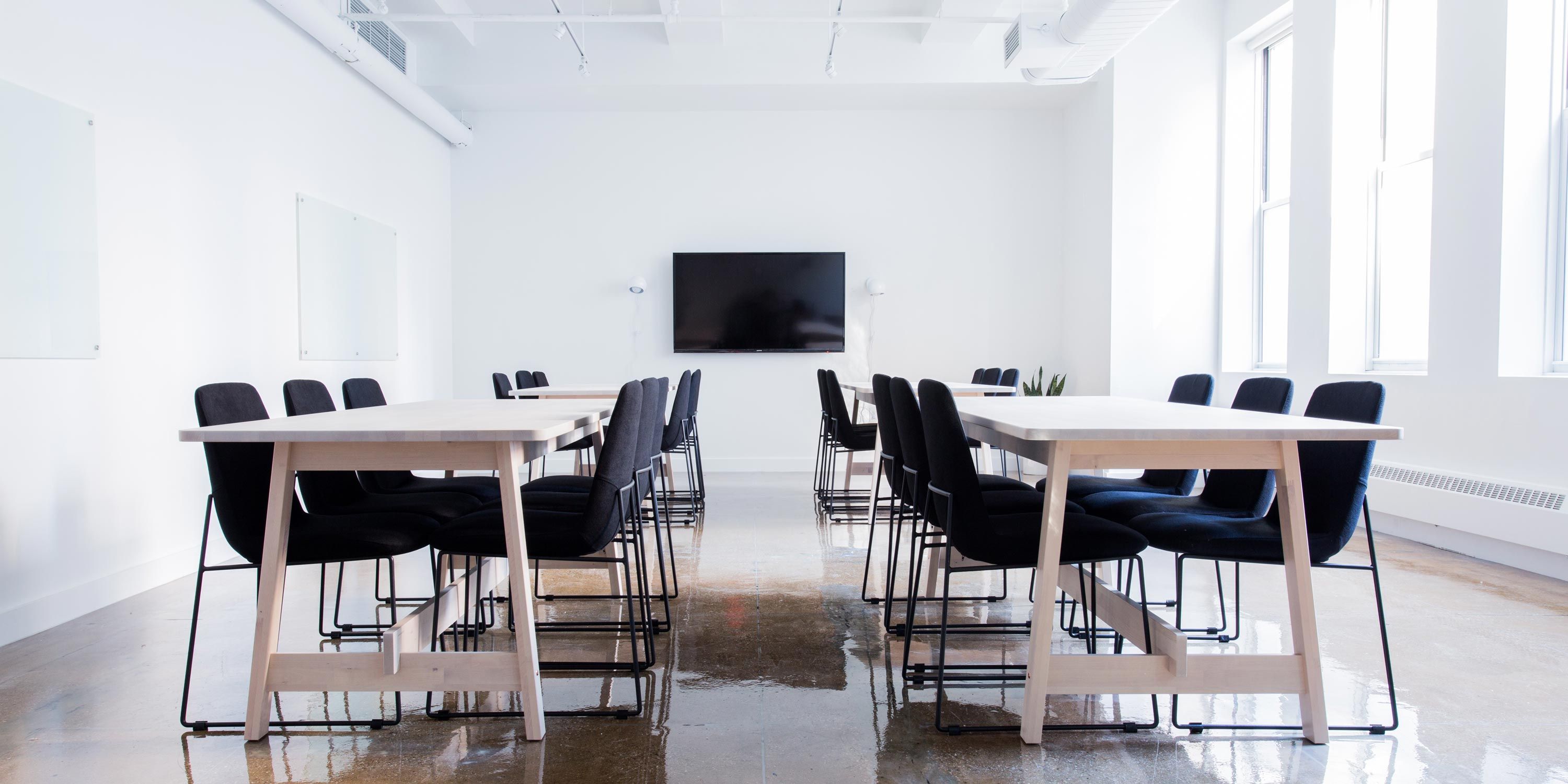 huddle room, smart home technology, black chairs at wooden tables